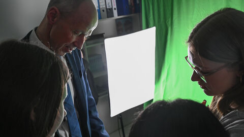 Eine Schülerin zeigt Armin Schwarz etwas.